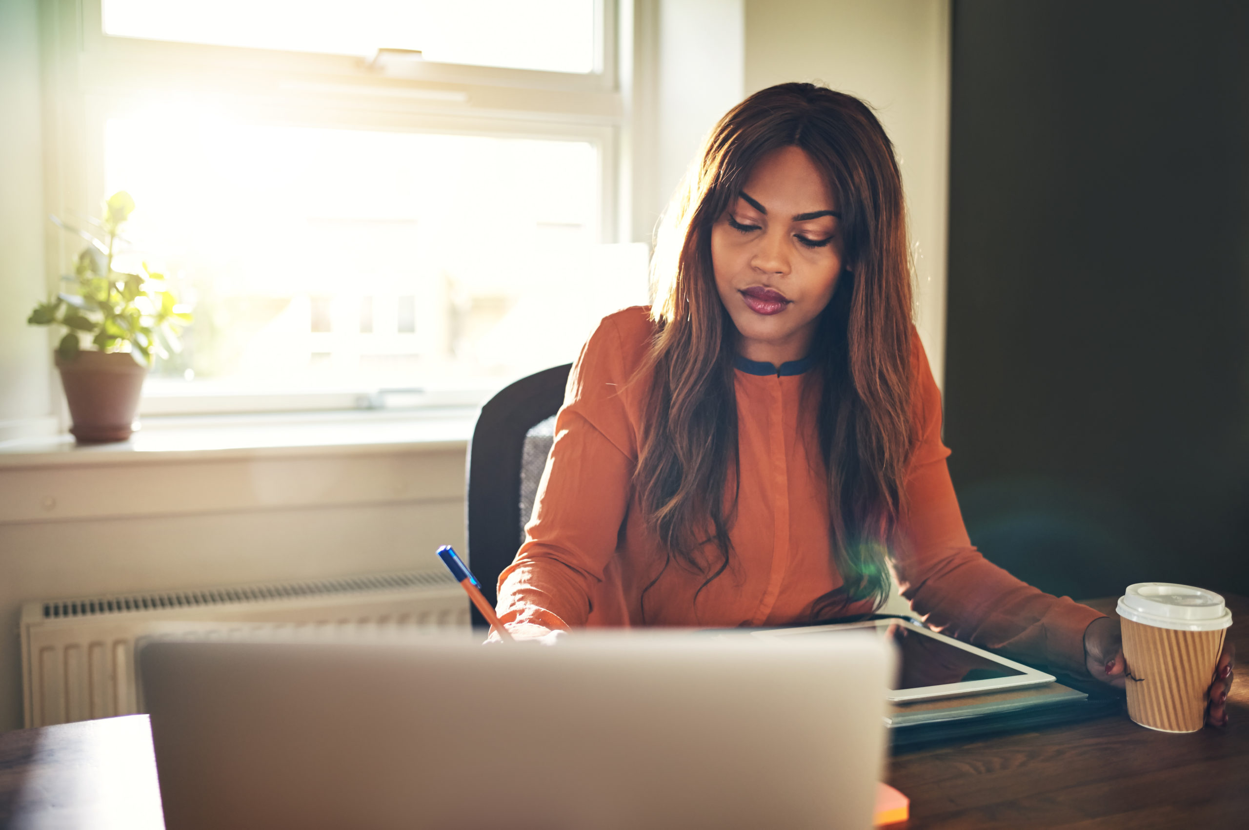 Young woman working at a desk in her home office